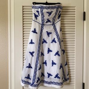 White dress with blue cobalt embroided flowers.